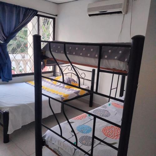 a black bunk bed in a room with a window at El Podio, casa quinta vacacional Ricaurte in Ricaurte