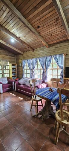 a living room with purple couches and a table at Paradise of Atitlan in Santiago Atitlán
