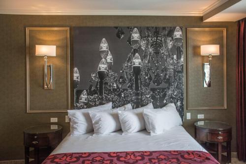 a bedroom with a bed with a painting on the wall at The Delavan Hotel in Buffalo