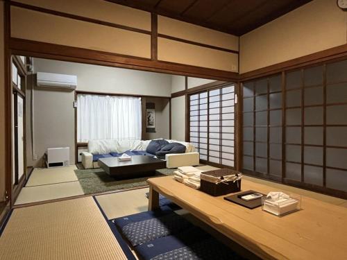 a living room with a couch and a table at Irest Village Matsumoto in Matsumoto