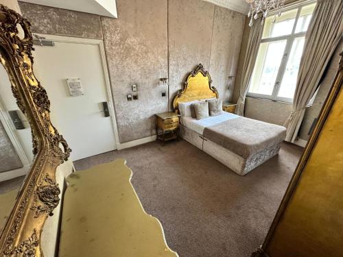 a bedroom with a bed and a large mirror at White Star Line Hotel in Liverpool