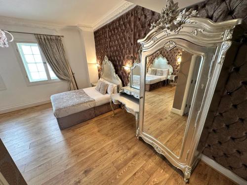 a bedroom with a large mirror and a bed at White Star Line Hotel in Liverpool
