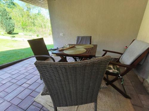 a patio with a table and chairs and a laptop at Casa Narcisa in Verneşti