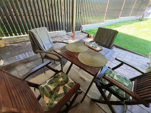 a patio with two chairs and a wooden table with at Casa Narcisa in Verneşti