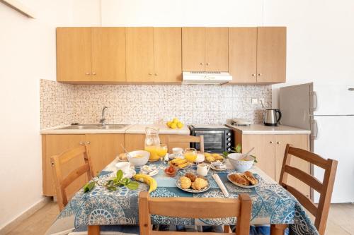 a kitchen with a table with food on it at Averto in Benitses