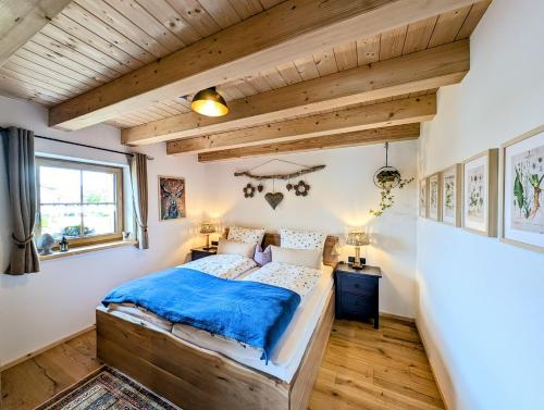 a bedroom with a bed and a wooden ceiling at Inser Hof - Hüttenleben Bayern in Mauth