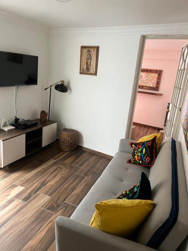 a living room with a couch and a flat screen tv at Casa en tlaquepaque in Guadalajara