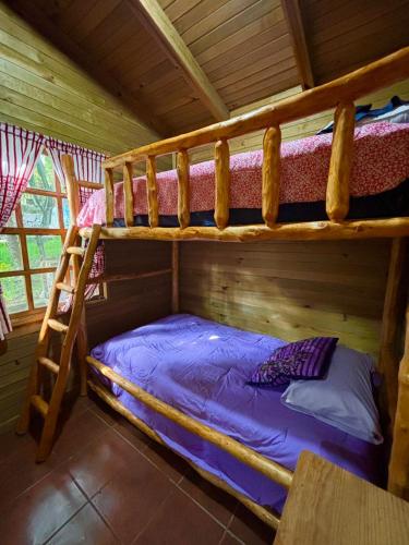 a bedroom with two bunk beds in a cabin at Paradise of Atitlan in Santiago Atitlán