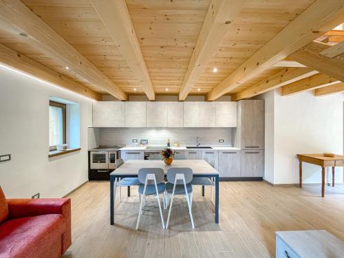 a kitchen and dining room with a table and chairs at Luxury Chalet Dolomiti-Campiglio-Trentino in Porte di Rendena