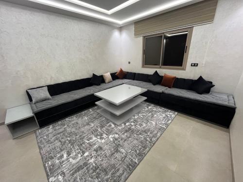 a living room with a couch and a table at Najla Sh4 in Tangier