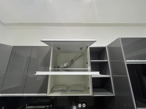 a kitchen cabinet with glass doors and shelves at Najla Sh4 in Tangier