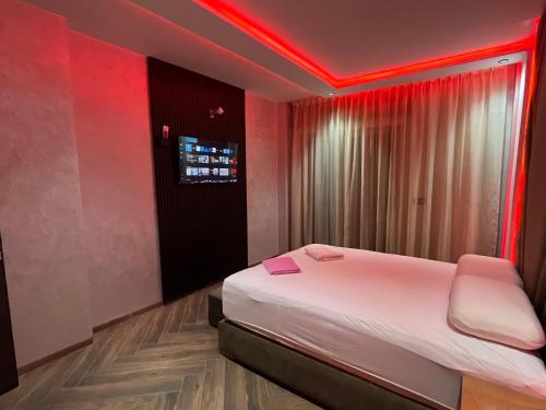 a bedroom with a bed with a red lighting at Najla Sh4 in Tangier