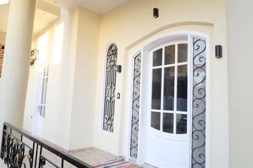 a front door of a home with wrought iron gates at Tomorrow Land villa in Luxor
