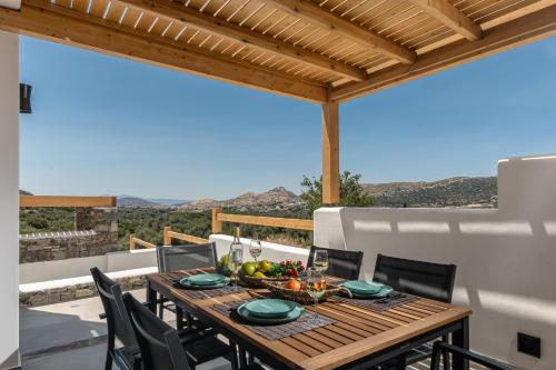 a wooden table with a bowl of fruit on a patio at Alkema Horizon in Philotium