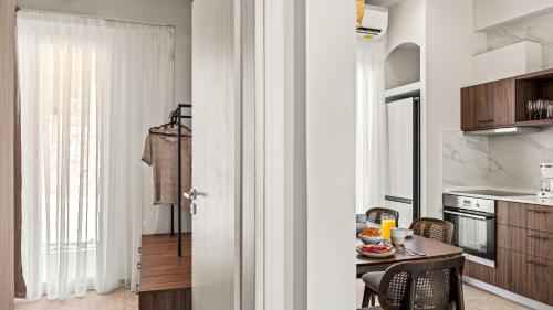a kitchen with a table and a dining room at Blue Dream - Beach Front Villa in Kastrí