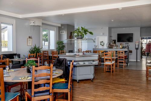 a restaurant with tables and chairs in a room at L Escale in Ports