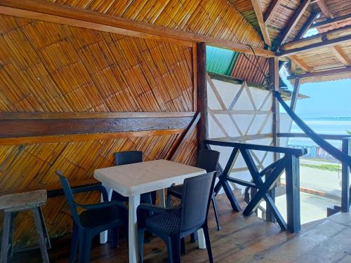 a dining room with a table and chairs in a hut at Hostal Mirada al Mar in Las Tunas