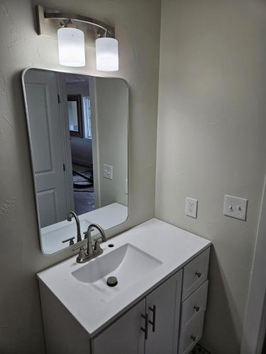 a bathroom with a sink and a mirror at Sunny Beautiful Apt, 2nd Level, 2Bedroom, 2Bath, Kitchen, Dining in Denver