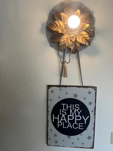 a sign with a flower on a wall with a light at B&B Apart Hotel Goldener Hahn - Hygge Pool & Sauna in Baiersbronn