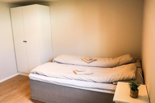 a small room with a bed and a cabinet at New apartment close to Preikestolen in Strand