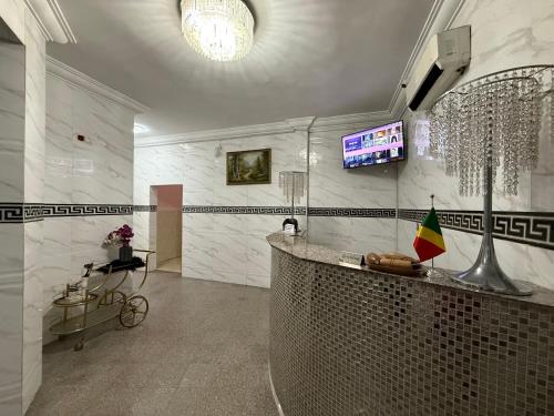 a lobby with a counter and a television in a room at SKY HoTEL in Brazzaville