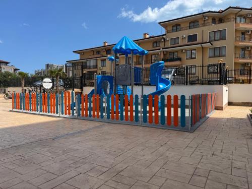 a playground in front of a building at Apartment Summer Vibes in Sveti Vlas