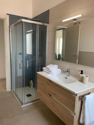 a bathroom with a sink and a glass shower at Villa SalSea in Marausa