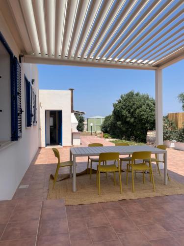 a patio with a table and chairs under awning at Villa SalSea in Marausa