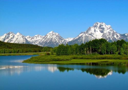 a view of a lake with mountains in the background at New Listing, Blue Cabin, Downtown, Cozy Getaway in Driggs