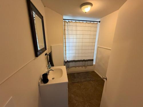 a small bathroom with a sink and a window at New Listing, Blue Cabin, Downtown, Cozy Getaway in Driggs