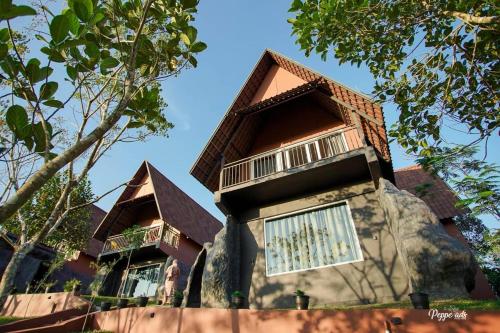 a house built on a rock with windows at Kap Korome Village Resort in Koroth