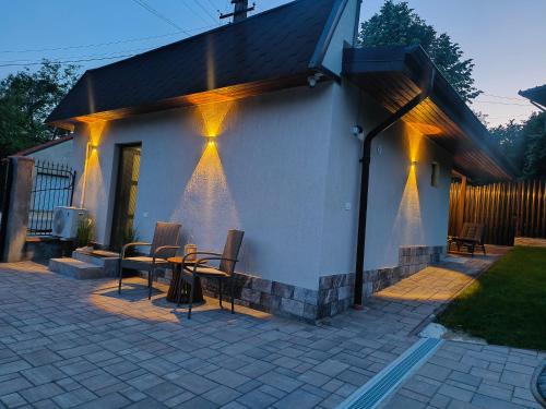 a house with lights on the side of it at Casa Narcisa in Verneşti