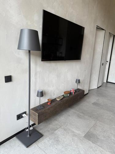 a living room with a flat screen tv on a wall at The Prut Lodge in Vorokhta