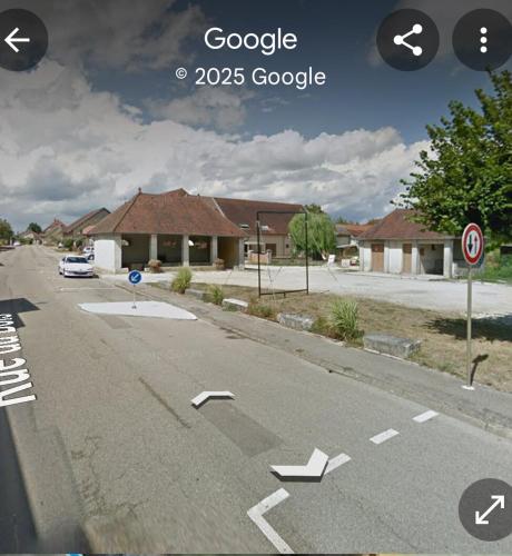 an empty street with arrows pointing towards a house at F2 appartement de campagne in Cramans