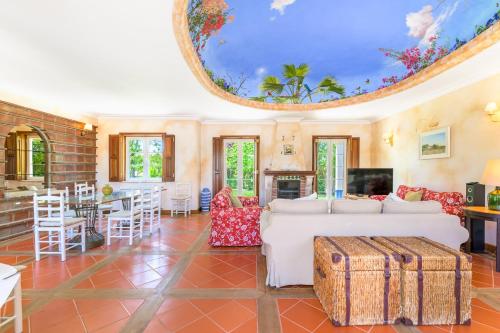 a living room with a white couch and a table at Quinta das Tílias in Santiago do Cacém