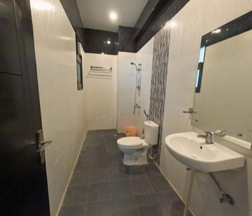 a bathroom with a toilet and a sink at GLOBAL Luxury Stay in Gurgaon