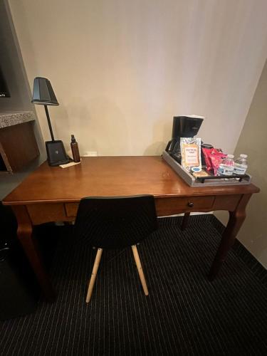 a wooden desk with a chair in a room at Hotel Boutique Querencia in Tijuana