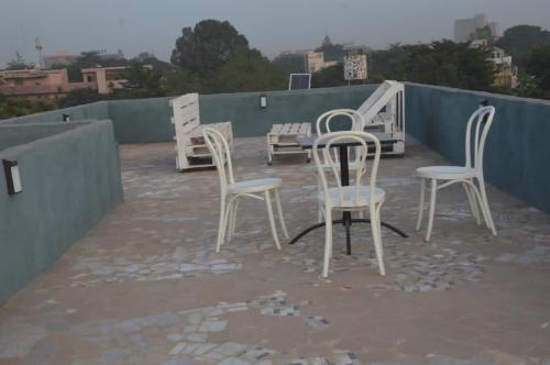 a group of chairs sitting on top of a roof at Torobali IMMO Apartment 4- Modern 1BDR- Near Embassies and Restaurants- Secure Building in Bamako