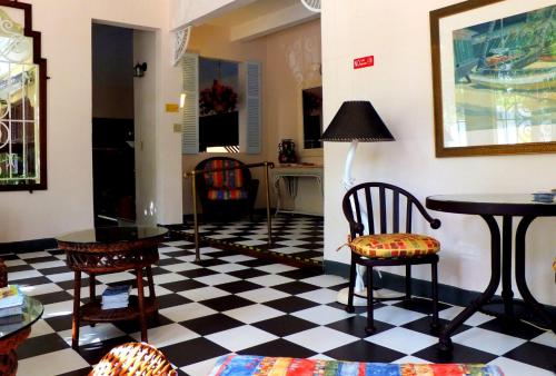 a living room with a black and white checkered floor at Canario Boutique Hotel in San Juan