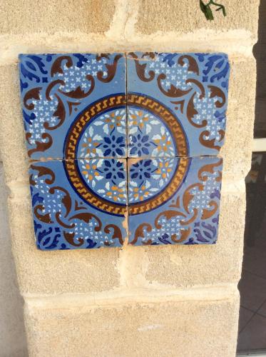 a blue clock on the side of a building at Favignana Vacanze in Favignana