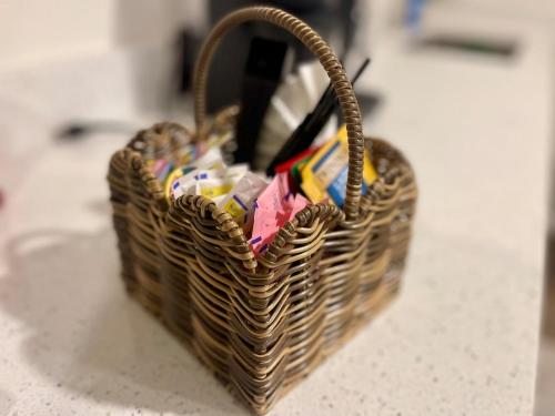 a wicker basket sitting on a counter with packets at 2 Kitchens, Pool, Ping Pong, Corn Hole, BBQ in Venice