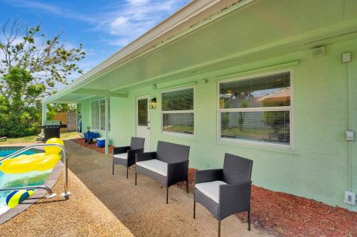 a green house with chairs next to a swimming pool at 2 Kitchens, Pool, Ping Pong, Corn Hole, BBQ in Venice