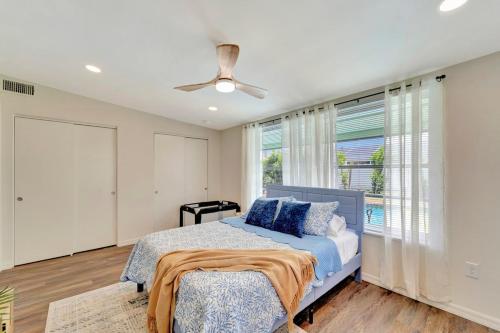 a bedroom with a bed and a ceiling fan at 2 Kitchens, Pool, Ping Pong, Corn Hole, BBQ in Venice