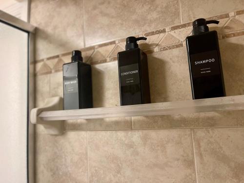 three cell phones sitting on a shelf in a bathroom at 2 Kitchens, Pool, Ping Pong, Corn Hole, BBQ in Venice