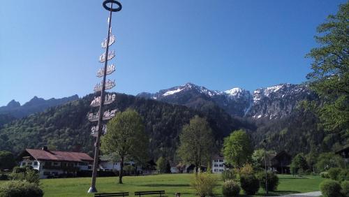 a pole in a field with mountains in the background at Kurhotel Rupertus in Bad Reichenhall