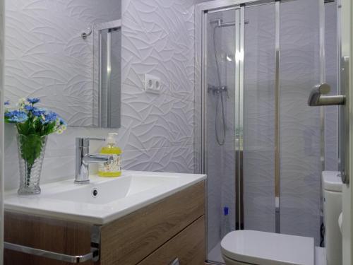 a bathroom with a toilet and a sink and a shower at ELIO Murcia El Carmen in Murcia