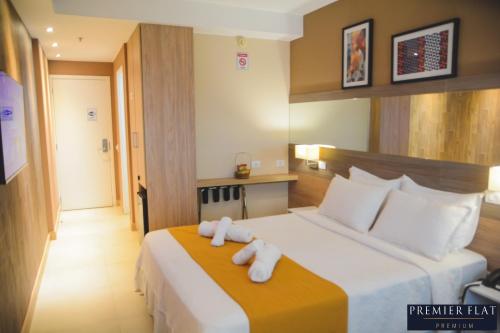 Postel nebo postele na pokoji v ubytování Premier Flat Premium Queimados