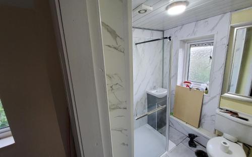 a bathroom with a shower and a toilet and a sink at Sure stay property in Bolton