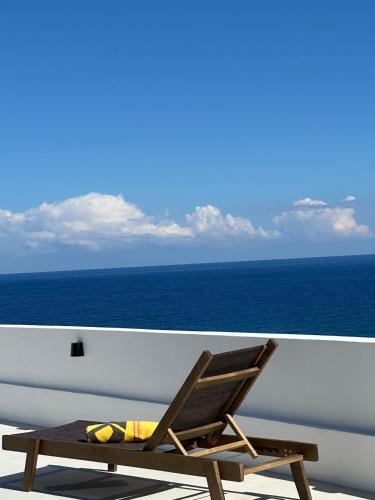 a chair sitting on the deck of a cruise ship at Villa Yimaré mit privatem Pool und Meerblick in Gázion