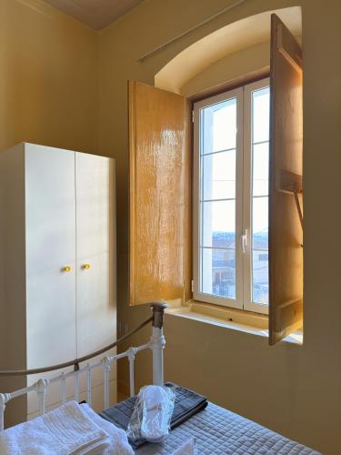 a bedroom with a bed and a window at Traditional Stone House in Kranidi